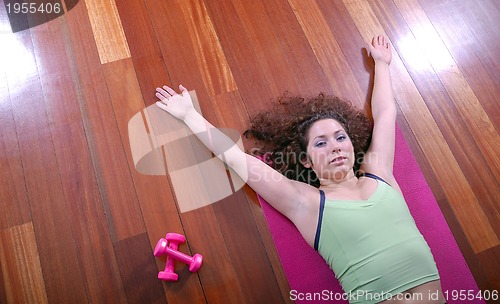 Image of prety girl laying on back in fitness studio