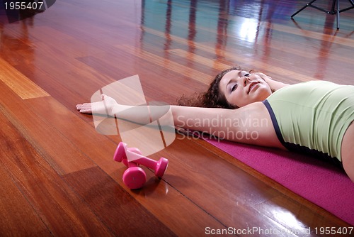 Image of prety girl laying on back in fitness studio