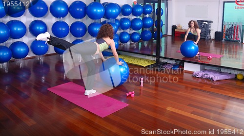 Image of young pretty woman exercising in a fitness center