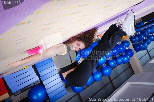 Image of pretty girl warming up in fitness studio