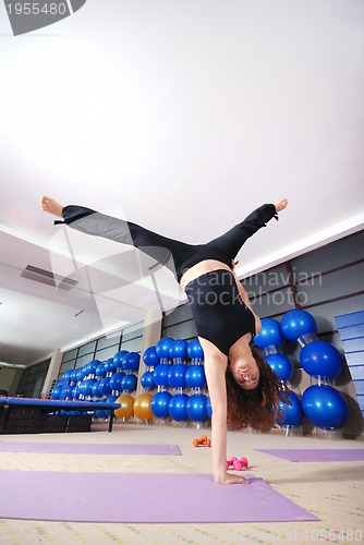 Image of healthy woman exercising in fitness club