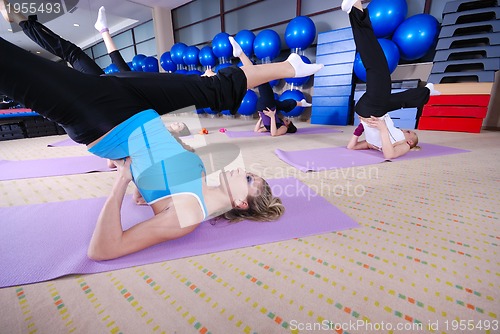 Image of health club: women doing stretching and aerobics
