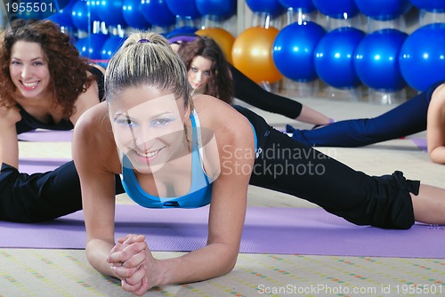 Image of beautiful young girls working out in a gym