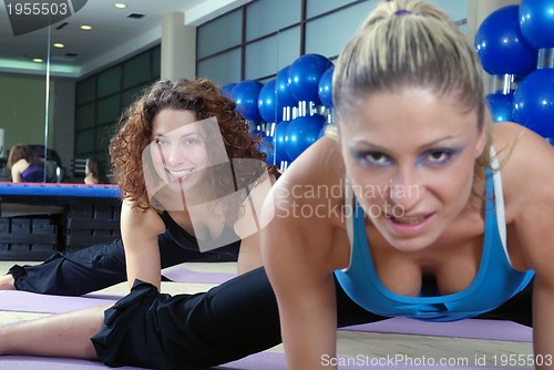 Image of beautiful young girls working out in a gym