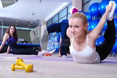 Image of beautiful young girls working out in a gym