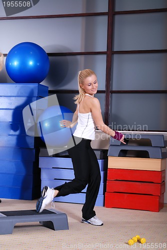 Image of woman stepping in a fitness center