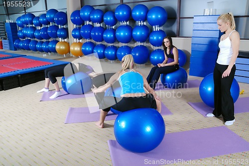 Image of beautiful young girls working out in a gym