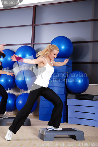 Image of woman stepping in a fitness center