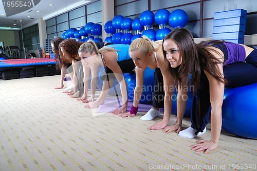 Image of beautiful young girls working out in a gym