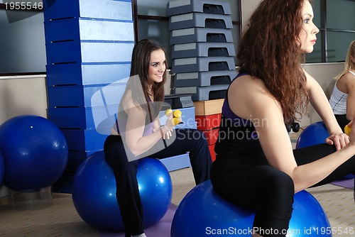 Image of beautiful young girls working out in a gym