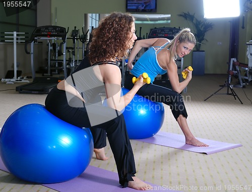 Image of beautiful young girls working out in a gym