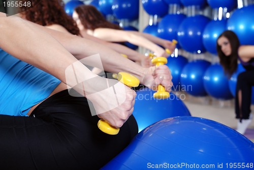 Image of beautiful young girls working out in a gym