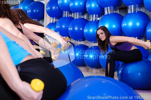 Image of beautiful young girls working out in a gym