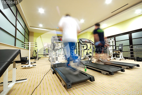 Image of Man running on treadmill in gym