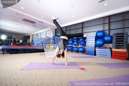 Image of Pretty girl exercising in a fitness studio