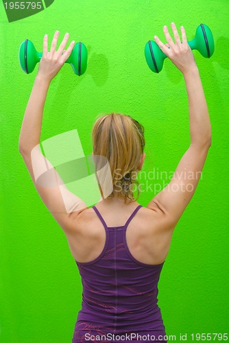 Image of pretty woman with dumbbell