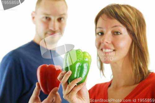 Image of happy couple with peppers isolated