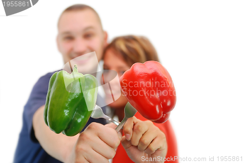 Image of happy couple with peppers isolated