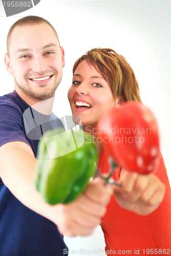 Image of happy couple with peppers isolated