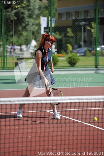 Image of young woman play tennis game outdoor