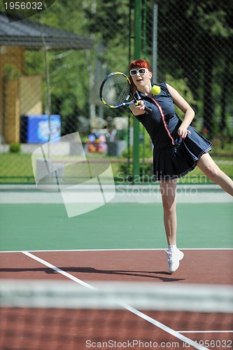 Image of young woman play tennis game outdoor