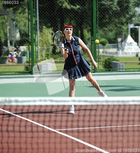 Image of young woman play tennis game outdoor