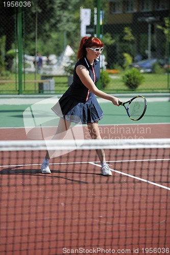 Image of young woman play tennis game outdoor