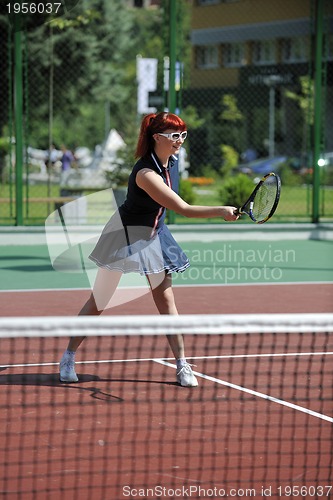 Image of young woman play tennis game outdoor