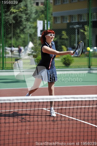 Image of young woman play tennis game outdoor