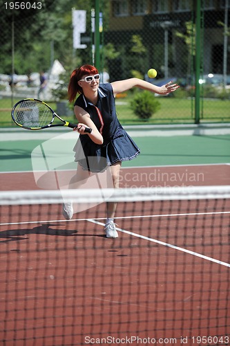 Image of young woman play tennis game outdoor