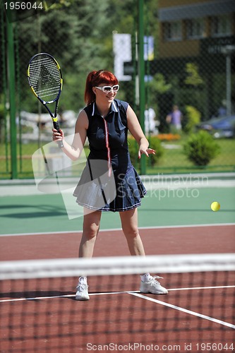 Image of young woman play tennis game outdoor