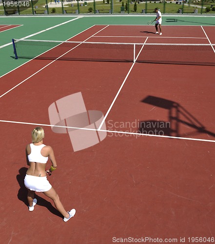 Image of young woman play tennis game outdoor
