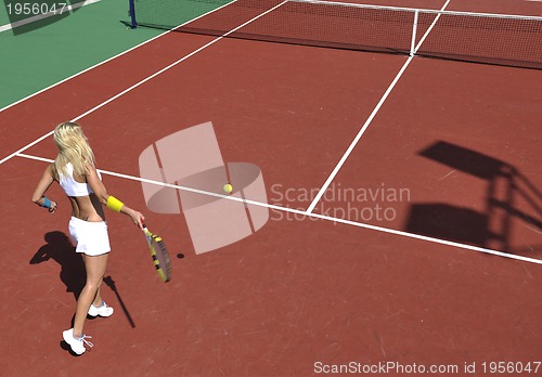 Image of young woman play tennis game outdoor