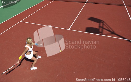Image of young woman play tennis game outdoor