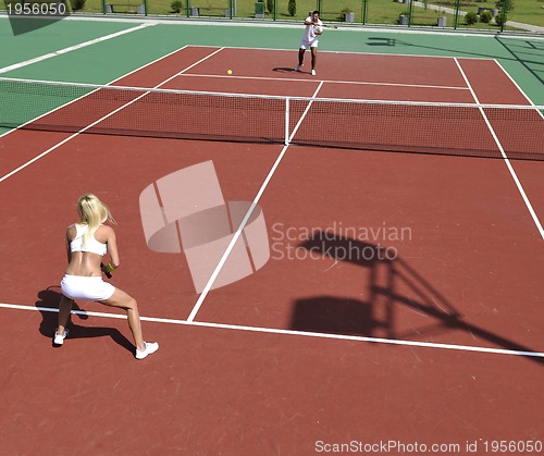 Image of young woman play tennis game outdoor