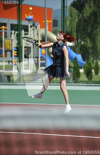 Image of young woman play tennis game outdoor