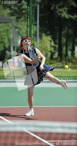 Image of young woman play tennis game outdoor