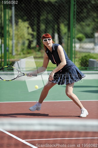 Image of young woman play tennis game outdoor