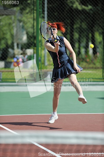 Image of young woman play tennis game outdoor