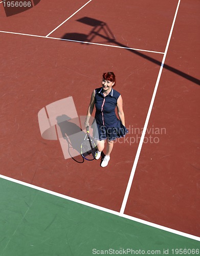 Image of young woman play tennis game outdoor
