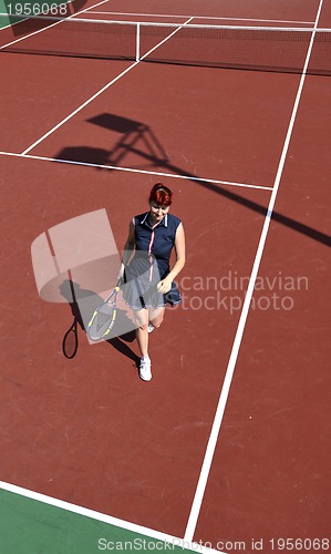 Image of young woman play tennis game outdoor