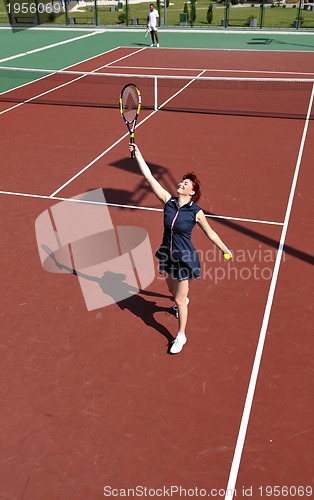 Image of young woman play tennis game outdoor