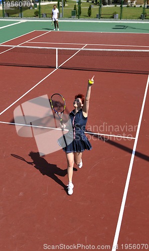 Image of young woman play tennis game outdoor