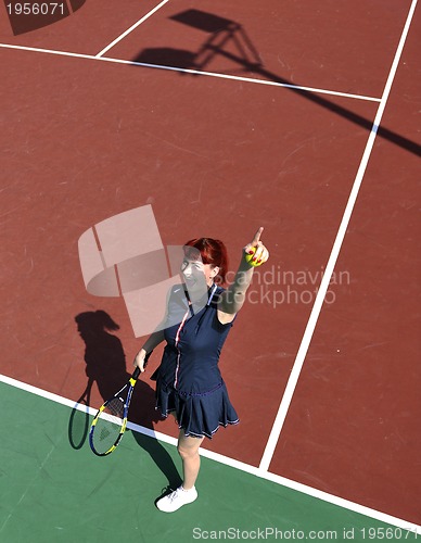 Image of young woman play tennis game outdoor
