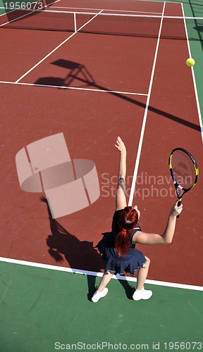 Image of young woman play tennis game outdoor