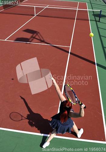 Image of young woman play tennis game outdoor