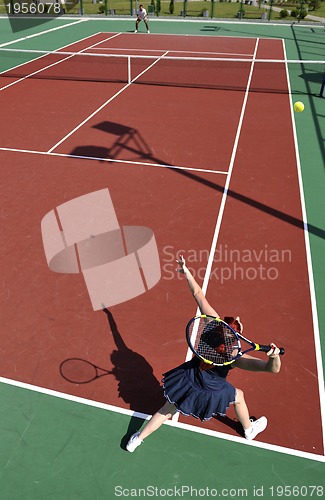 Image of young woman play tennis game outdoor