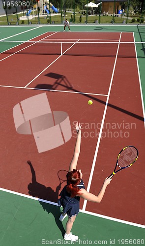 Image of young woman play tennis game outdoor