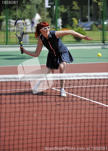 Image of young woman play tennis game outdoor