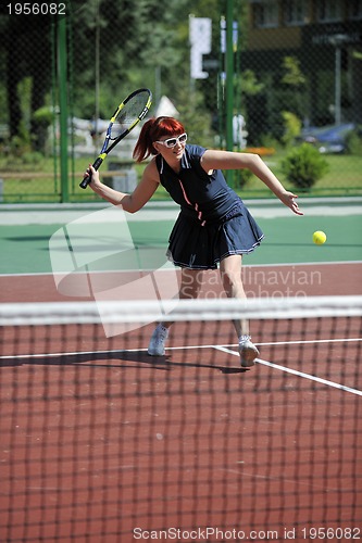Image of young woman play tennis game outdoor